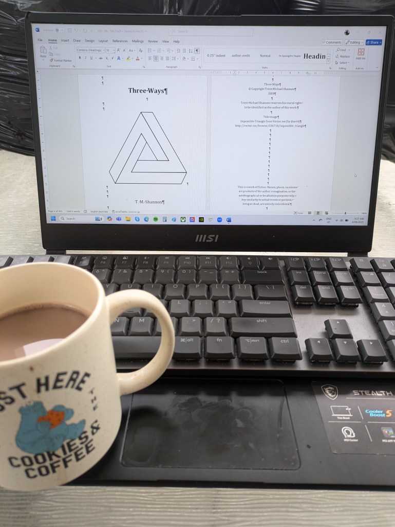 A portrait of the author's laptop featuring the title page of the WIP Three Ways, with a Cookie Monster coffee cup that says "Just Here for the Cookies and Coffee."